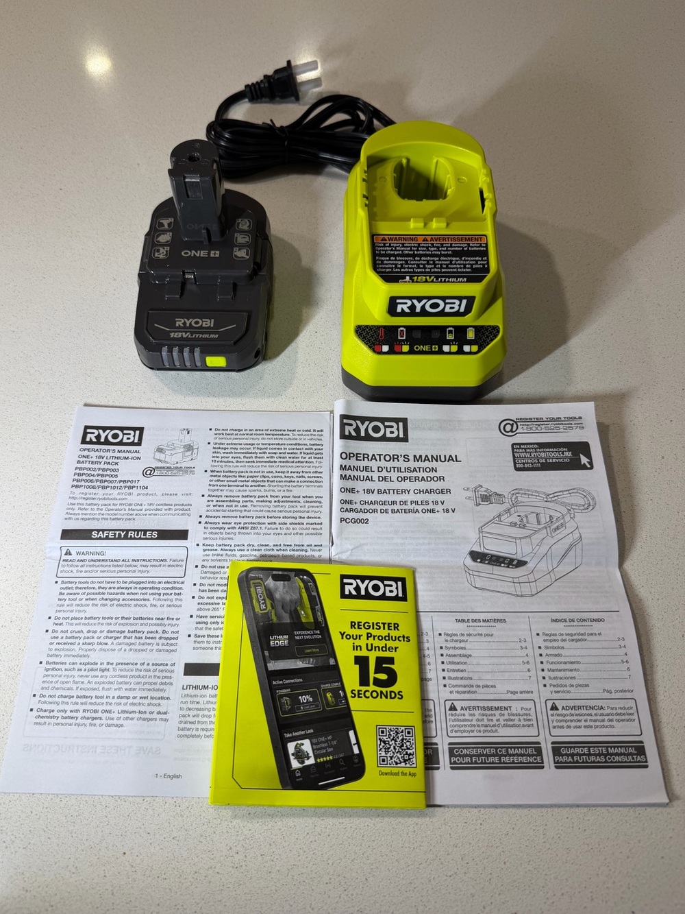 Ryobi ONE+ 18V Battery and Charger Kit with manuals.